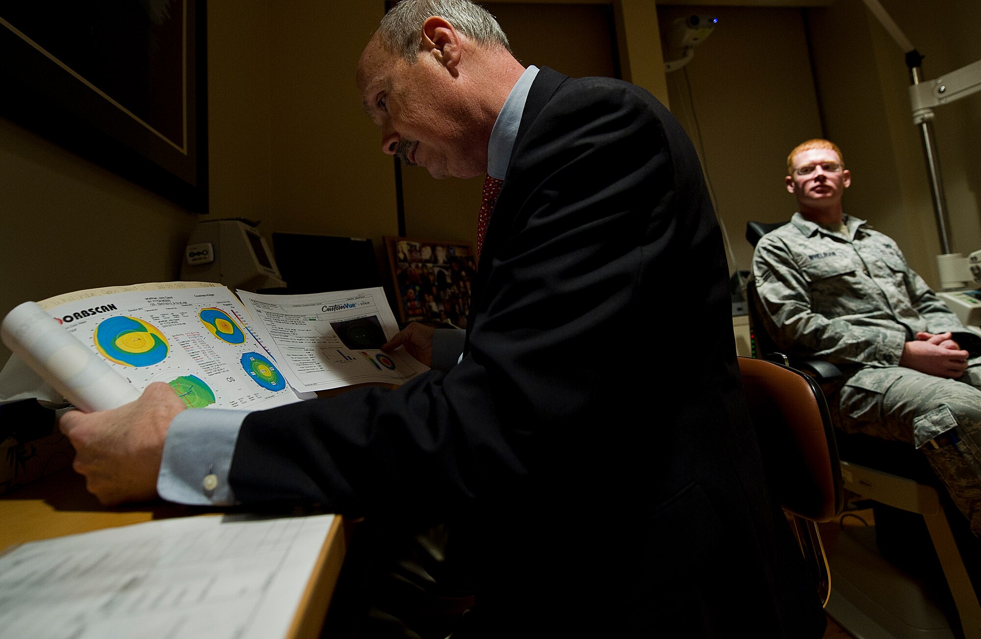 James Colgain, 779th Medical Group optometrist, reviews 811th Security Forces Squadron response force member, Airman 1st Class J.D. Whelihan’s orbscan and wavescan results, at Joint Base Andrews, Md. Dr. Colgain will use this information and other measurements to determine if the patient is a candidate for refractive surgery. (U.S. Air Force photo/Staff Sgt. Perry Aston)