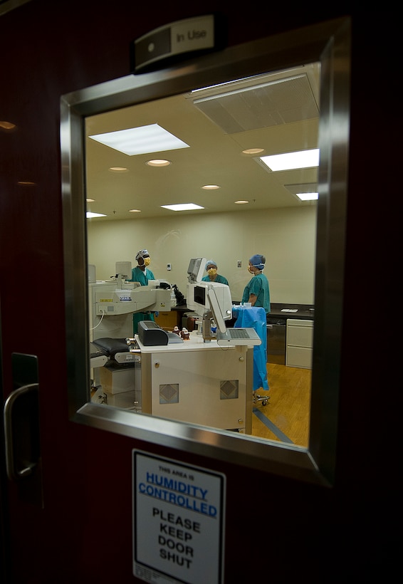 Kelvin Branch, certified ophthalmic assistant; Col. Joseph A. Giovannini, M.D.; and Kara Fernald, certified ophthalmic assistant with the 779th Medical Group, prepare the laser surgery room for the next patient at Joint Base Andrews, Md. The Warfighter Eye Center performs approximately 20 surgeries a week for patients stationed all over their world. (U.S. Air Force photo by Staff Sgt. Perry Aston