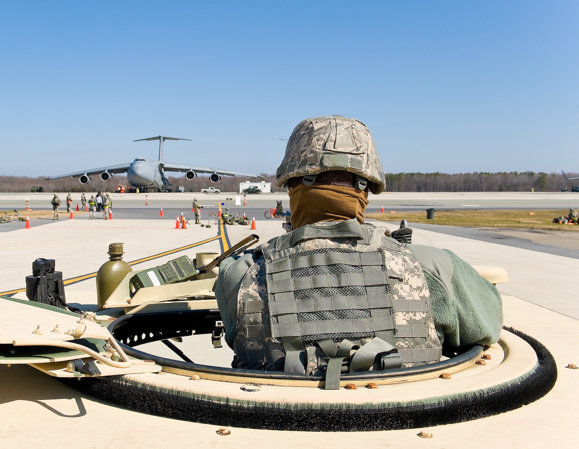 Airman 1st Class Andrew Basler, of the 436th Security Forces Squadron, stands guard in the turret of a Humvee Mar. 5, 2013, at Dover Air Force Base, Del. More than 250 members from the 436th Airlift Wing participated in the joint Operational Readiness Exercise March 2-8, at Dover AFB. (U.S. Air Force photo/Roland Balik)