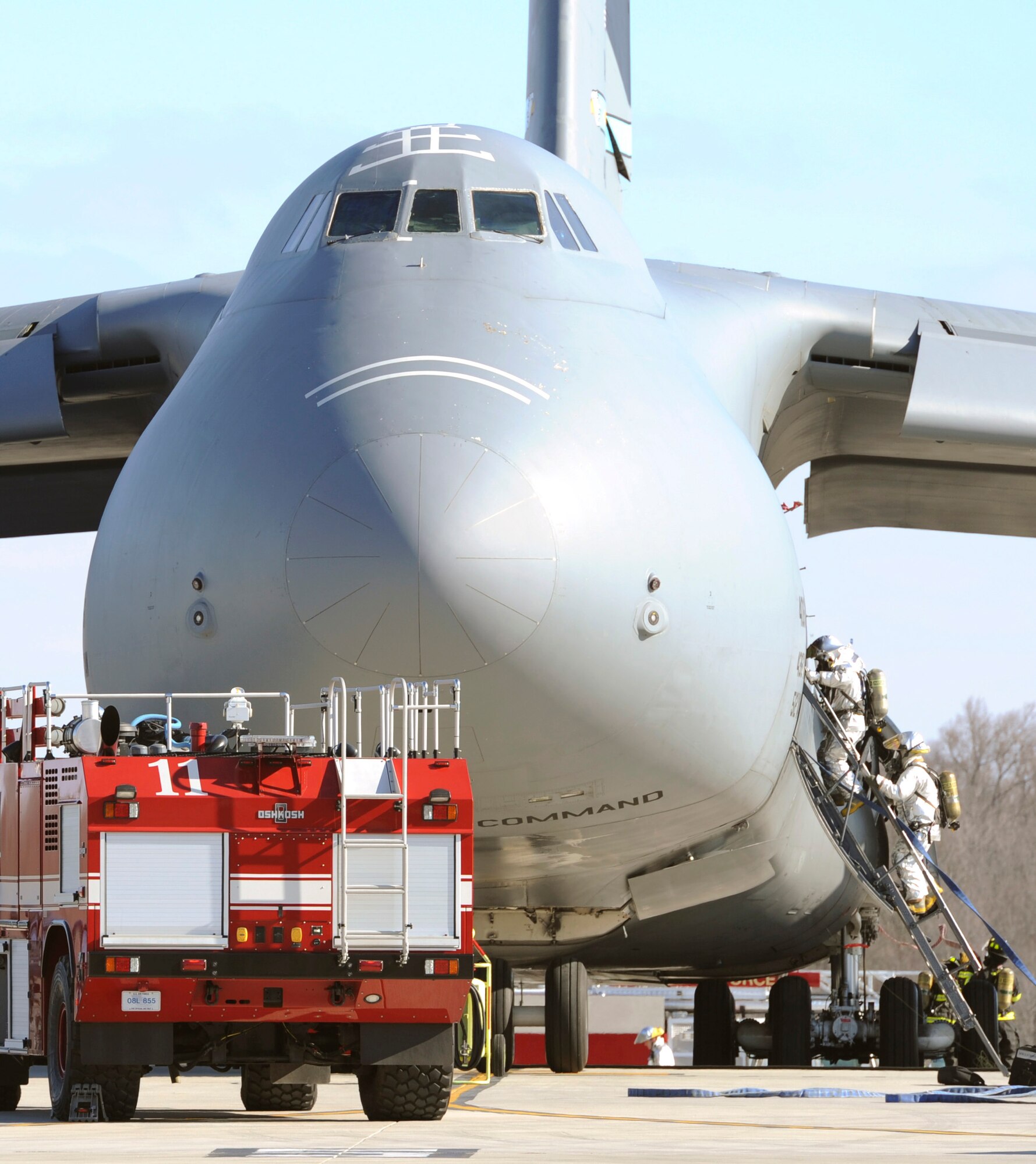 Members of the 436th Civil Engineer Squadron Fire Department respond to a simulated fire alert inside a C-17 Globemaster III Mar. 4, 2013, at Dover Air Force Base, Del. Over 400 members of the 436th and 512th Airlift Wings participated in a joint Operational Readiness Exercise Mar. 2-8. (U.S. Air Force photo/Master Sgt. Jeanette Spain)