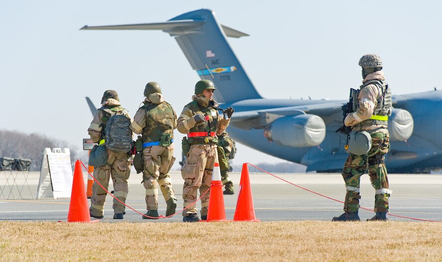 Airman 1st Class Moses McDonald, right, of the 436th Security Forces Squadron, stands guard at a flight line entry control point Mar. 5, 2013, at Dover Air Force Base, Del. Over 400 Team Dover members from the 436th and 512th Airlift Wings participated in the joint Operational Readiness Exercise March 2-8. (U.S. Air Force photo/Roland Balik)