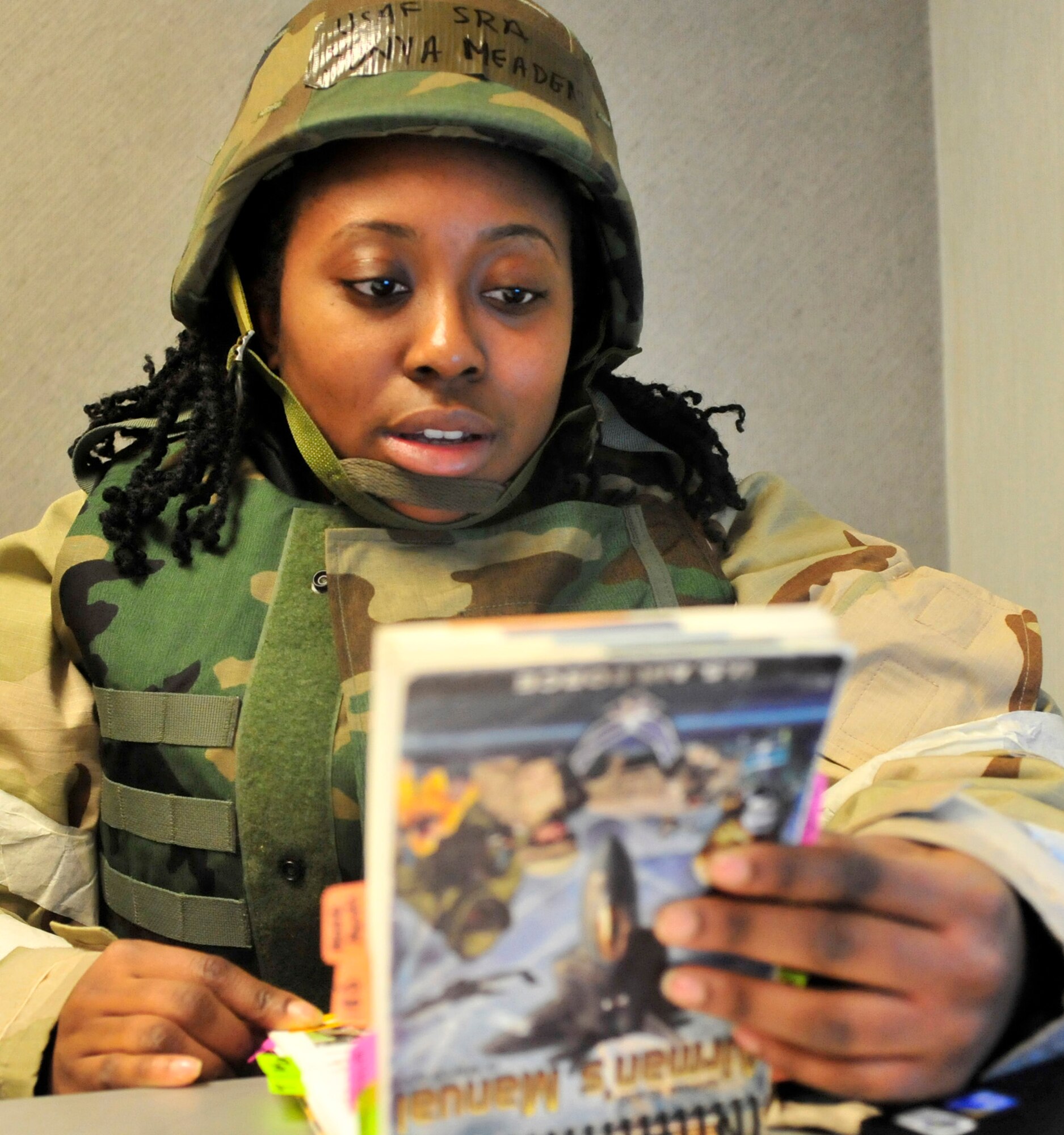 Senior Airman Sonya Meaders, 436th Comptroller Squadron, reads the Airman’s Manual during the Operational Readiness Exercise Mar. 5, 2013, at Dover Air Force Base, Del. More than 400 members of the 436th and 512th Airlift Wings participated in a joint ORE Mar. 2-8. (U.S. Air Force photo/Tech. Sgt. Chuck Walker)