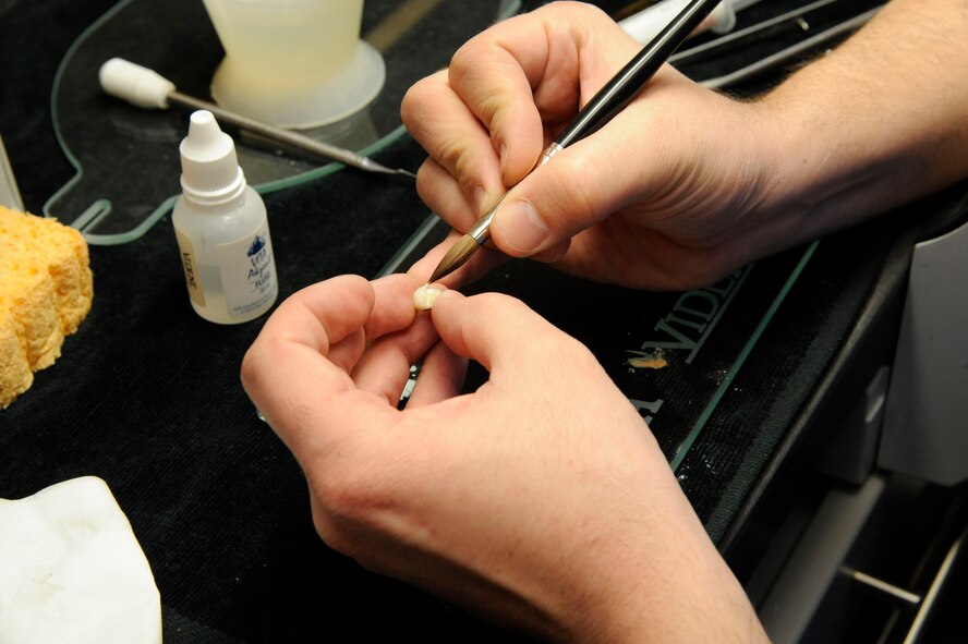 Staff Sgt. Christopher Casey, 2nd Dental Squadron dental lab assistant, applies porcelain to a dental crown on Barksdale Air Force Base, La., March 12. The dental laboratory provides assistance to the 2 DS by providing doctors with the equipment they need such as fabricating prostheses, creating molds of patient's teeth and providing accurate dental imagery. (U.S. Air Force photo/Airman 1st Class Andrew Moua)