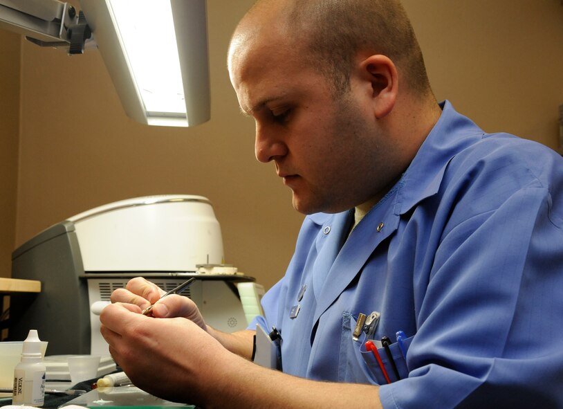 Staff Sgt. Christopher Casey, 2nd Dental Squadron dental lab assistant, applies porcelain to a dental crown on Barksdale Air Force Base, La., March 12. The dental laboratory provides assistance to the 2 DS by providing doctors with the equipment they need such as fabricating prostheses, creating molds of patient's teeth and providing accurate dental imagery. (U.S. Air Force photo/Airman 1st Class Andrew Moua)