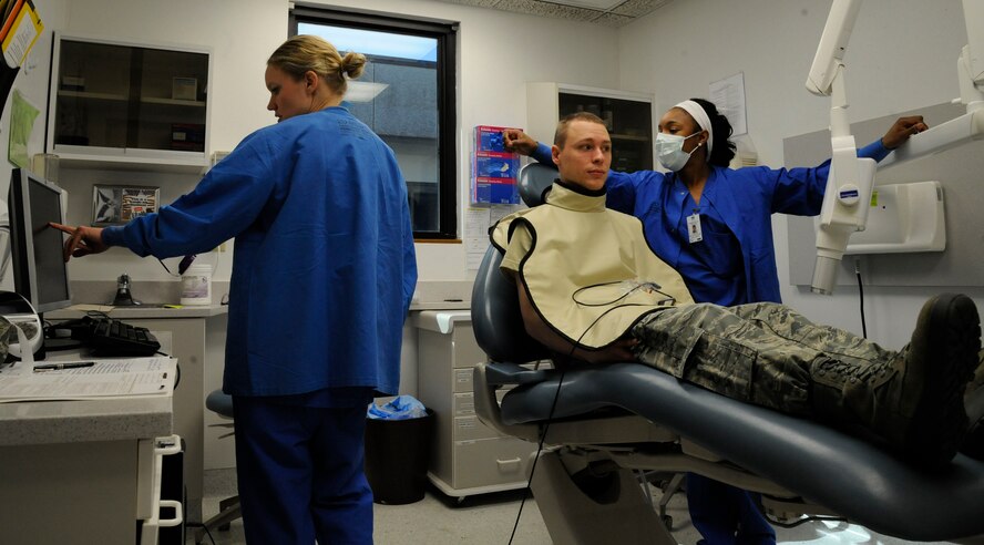 Capt. Lindsey Merchant, 2nd Dental Squadron general dentist, and Olivia Cotto-Hernandez, 2 DS dental assistant, examine an Airman's dental X-rays on Barksdale Air Force Base, La., March 12. Examinations serve to get a general health assessment of a patient's teeth. If anything abnormal is found, doctors may then refer the patient for treatment. (U.S. Air Force photo/Airman 1st Class Andrew Moua)
