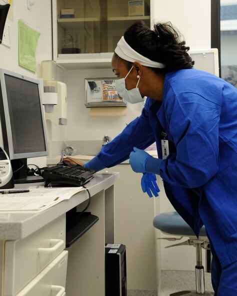 Olivia Cotto-Hernandez, 2nd Dental Squadron dental assistant, examines dental X-rays on Barksdale Air Force Base, La., March 12. The 2 DS provides care for Team Barksdale's dental needs ranging from oral surgery, dental X-rays and dental hygiene. (U.S. Air Force photo/Airman 1st Class Andrew Moua)