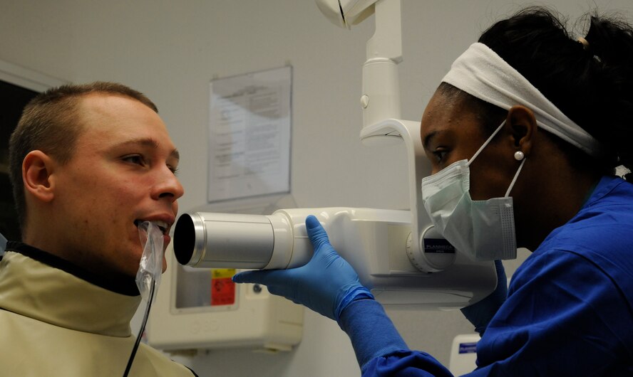 Olivia Cotto-Hernandez, 2nd Dental Squadron dental assistant, X-rays Airman 1st Class Benjamin Raughton, 2nd Bomb Wing, during a dental exam on Barksdale Air Force Base, La., March 12. The 2 DS provides care for Team Barksdale's dental needs ranging from oral surgery, dental X-rays and dental hygiene. (U.S. Air Force photo/Airman 1st Class Andrew Moua)