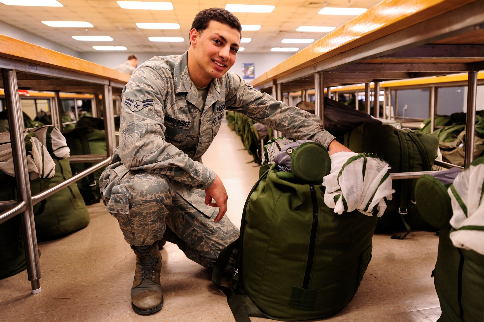 U.S. Air Force Airman1st Class, Lyonel Degaldo-Perez, an aircrew flight equipment maintainer for 1st Special Operations Support Squadron, posing with one of the aircrew bags he maintains during his routine checkups. Delgaldo Perez was selected for this week's 'Tip of Spear' highlight. (U.S. Air Force Photo by Senior Airman Kentavist P. Brackin)

