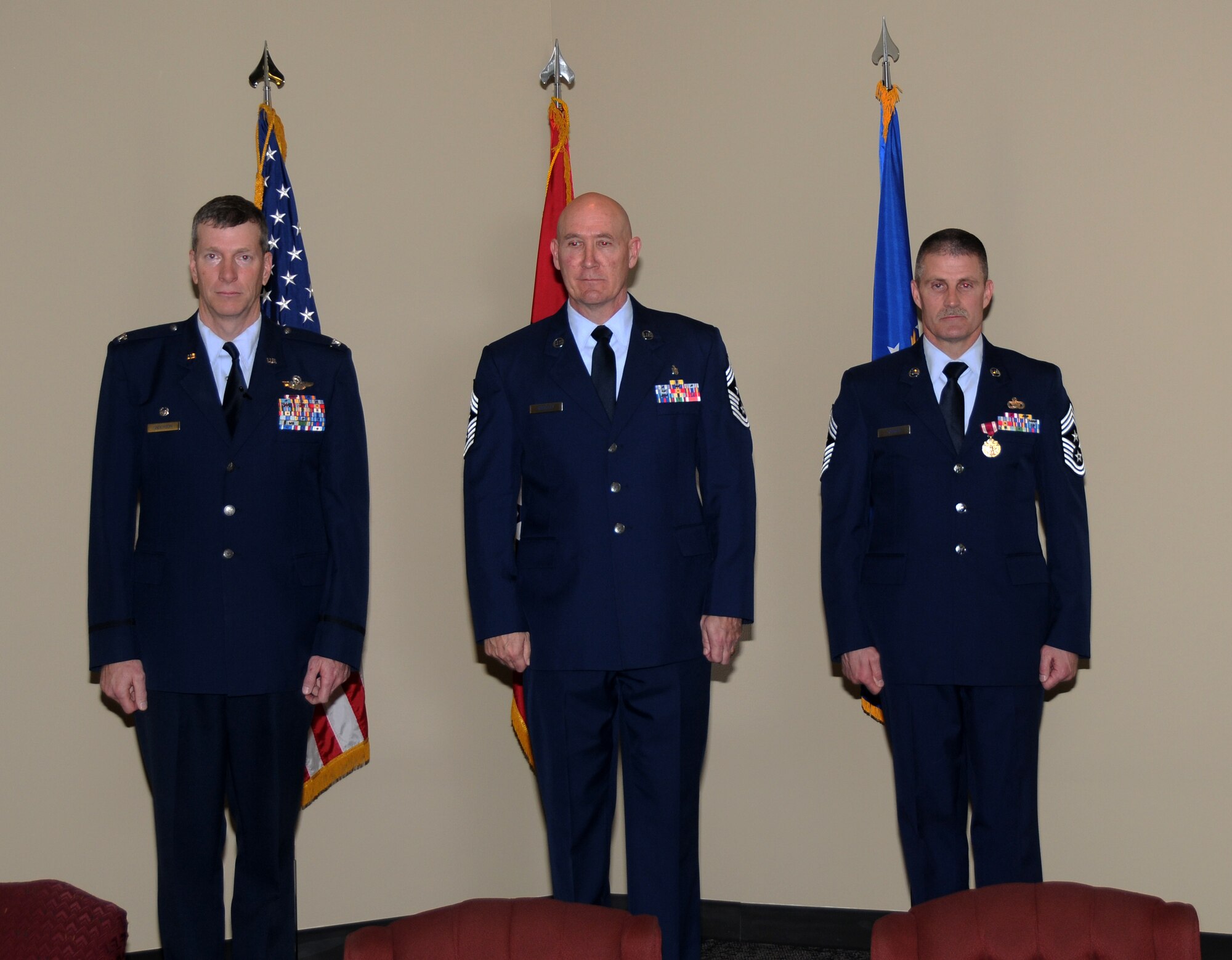 Col. Mark Anderson, 188th Fighter Wing commander; Chief Master Sgt. Asa Carter, outgoing 188th Fighter Wing command chief; and Chief Master Sgt. Stephen Bradley, incoming 188th Fighter Wing command chief, stand at attention following a command chief change of authority ceremony March 3, 2013, at the 188th. Carter relinquished authority to Bradley during the ceremony. Carter moves on to become the Arkansas Air National Guard’s state command chief. (National Guard photo by Senior Airman John Hillier/188th Fighter Wing Public Affairs)
