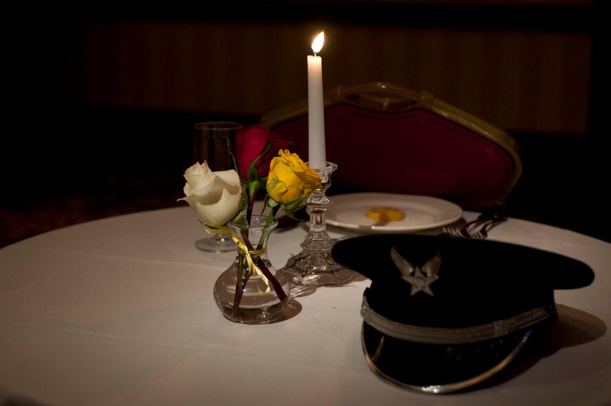 Commonplace among military functions is the Missing In Action/Prisoner of War table. The vase that holds the red, white and yellow roses represent those killed in action, those who have returned and those who are missing, respectively. The white table cloth underneath symbolizes the purity of an American service member’s intentions when responding to their country’s call to arms. The Missing in Action/Prisoner of War table was prominently set at the front of the banquet room for the 2013 Outstanding Airman of the Year Banquet (OAY) held March 9 at the JW Marriott Tucson Starr Pass Resort and Spa. (Air National Guard photo by Tech. Sgt. Hollie Hansen)