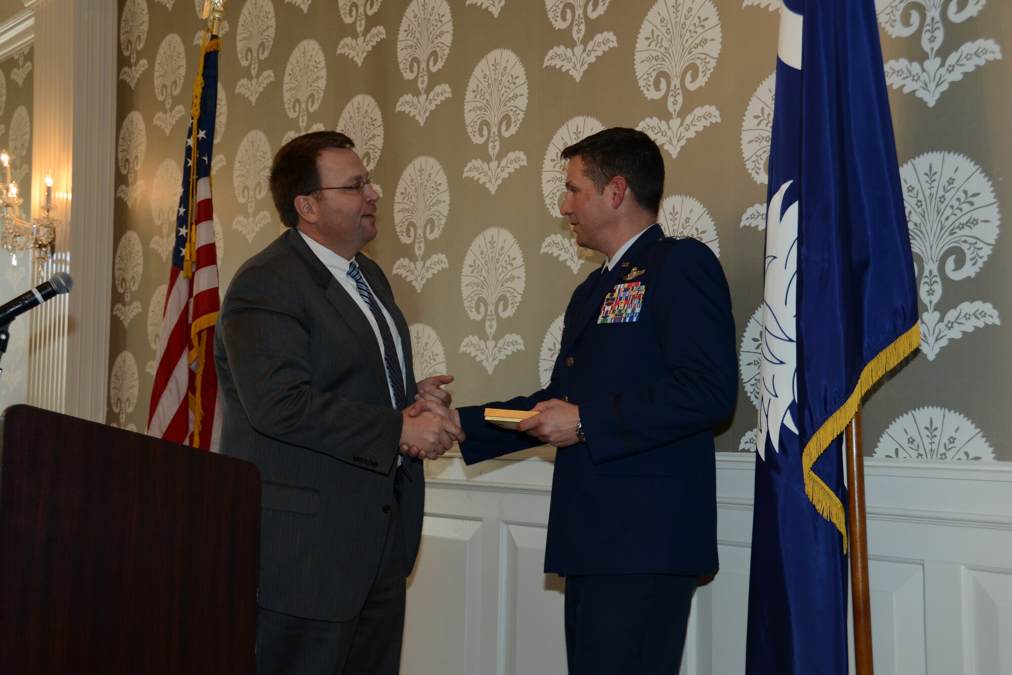 U.S. Air Force Col. Clay Hall, 20th Fighter Wing commander, is greeted by Will Holmes, Sumter Legislative Day chairman at Sumter Legislative Day at the Columbia, S.C. Statehouse March 6, 2013. Nearly 140 business and community leaders attended the event. (Photo by Capt. Ann Blodzinski/Released)
