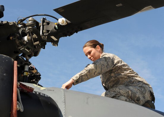 U.S. Air Force Staff Sgt. Danielle Murray, 723d Aircraft Maintenance Squadron dedicated crew chief (DCC), works on an HH-60G Pave Hawk at Moody Air Force Base, Ga., March 4, 2013. The DCC program gives recognition to multi-skilled aviation mechanics who excel in their job and as an Airman. (U.S. Air Force photo by Senior Airman Eileen Meier/Released)