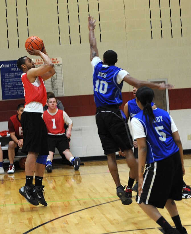 Senior Airman Deron Scott, 28th Munitions Squadron conventional maintenance technician, shoots from beyond the three-point line during the base 2013 Intramural Basketball League tournament in the Bellamy Fitness Center at Ellsworth Air Force Base, S.D., March 11, 2013. During February, all 10 teams in the league had an opportunity to face off against each other, with some teams setting themselves apart from the rest of the competition. (U.S. Air Force photo by Airman 1st Class Hrair H. Palyan/Released)
