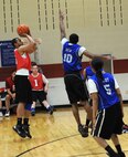 Senior Airman Deron Scott, 28th Munitions Squadron conventional maintenance technician, shoots from beyond the three-point line during the base 2013 Intramural Basketball League tournament in the Bellamy Fitness Center at Ellsworth Air Force Base, S.D., March 11, 2013. During February, all 10 teams in the league had an opportunity to face off against each other, with some teams setting themselves apart from the rest of the competition. (U.S. Air Force photo by Airman 1st Class Hrair H. Palyan/Released)