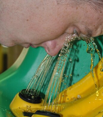 Airman 1st Class Christopher Kelley, 100th Aircraft Maintenance Squadron currently deployed to southwest Europe, demonstrates proper use of an eye-wash station March 6, 2013. Airmen from the 100th Air Refueling Wing, RAF Mildenhall, England, deployed to southwest Europe in January 2013 to support French operations in Mali. There were no eye-wash stations at the deployed location until Staff Sgt. Najim Alhamdan, 100th Maintenance Group, identified the need for the equipment and had it shipped from home station on a KC-135 Stratotanker tail swap. (U.S. Air Force photo by Staff Sgt. Alan Wilkinson)