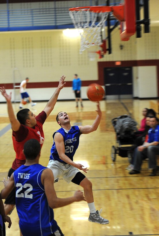 Airman 1st Class Richard Gere, 28th Civil Engineer Squadron electrical systems technician, lofts up a shot during the base 2013 Intramural Basketball League tournament in the Bellamy Fitness Center at Ellsworth Air Force Base, S.D., Feb. 21, 2013. The 28th CES team (B) squared off against the 28th Aircraft Maintenance Squadron, and won, 48-31. (U.S. Air Force photo by Airman 1st Class Hrair H. Palyan/Released)