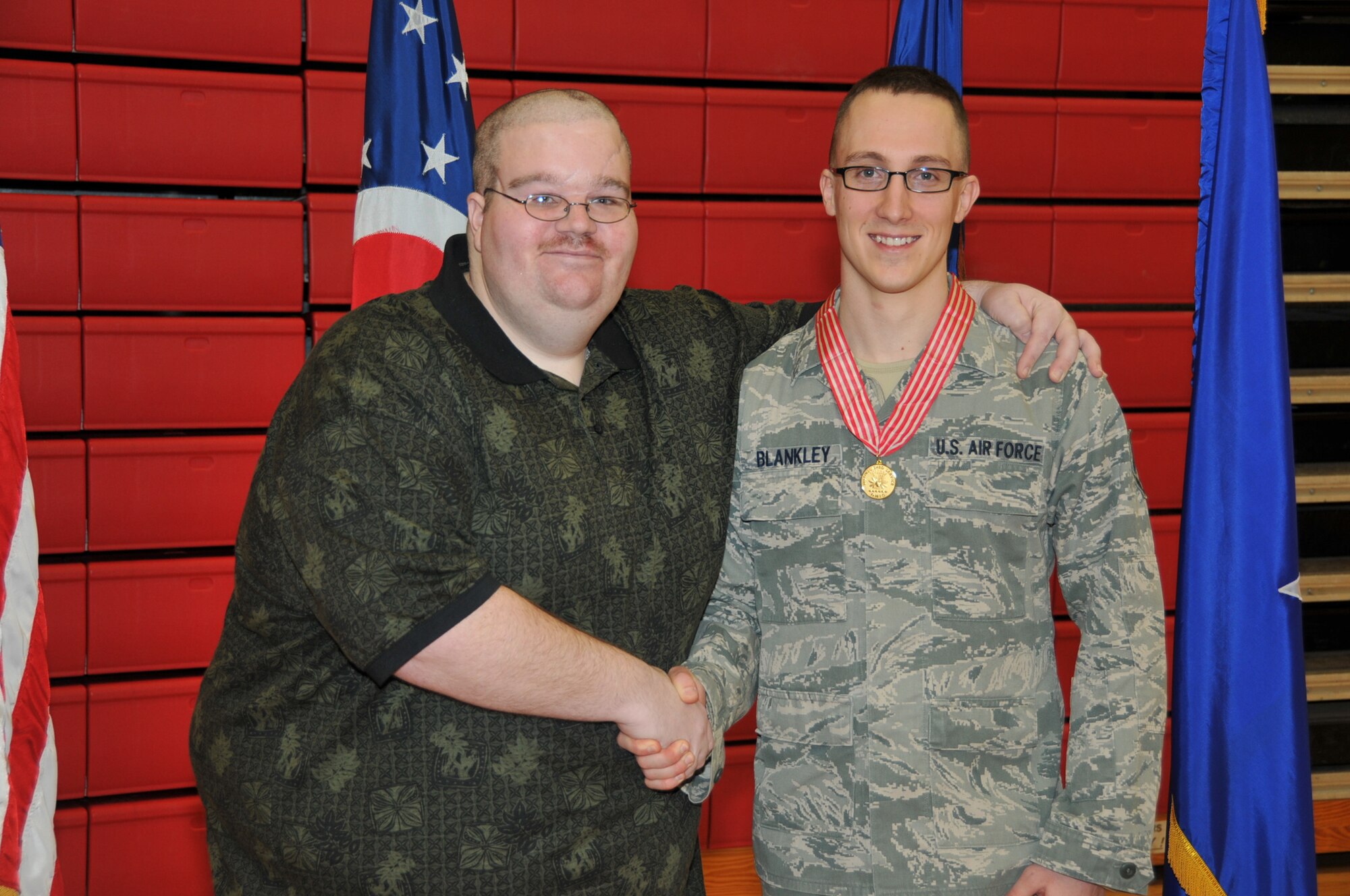 Staff Sgt. Josh Blankley with Ronald Alberding, a man Blankley rendered life-saving first aid to after a car accident on June 22, 2012.  Ohio Air National Guard Chief of Staff, Brig. Gen. Stephen E. Markovich awards Staff Sgt. Josh Blankley, 200th RED HORSE Squadron, the Ohio Distinguished Service Medal with the "V" device during a ceremony held at Camp Perry located in Port Clinton, Ohio, on March 9, 2013.  (U.S. Air Force photo by Staff Sgt. Joseph Harwood)