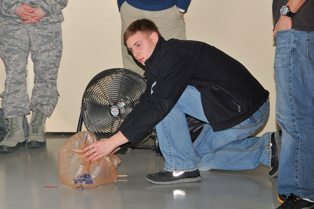 Cascade High School student Trevor Arnold tests his team’s vehicle design at the local National Engineers Week Design Competition. (Photo by Jacqueline Cowan)