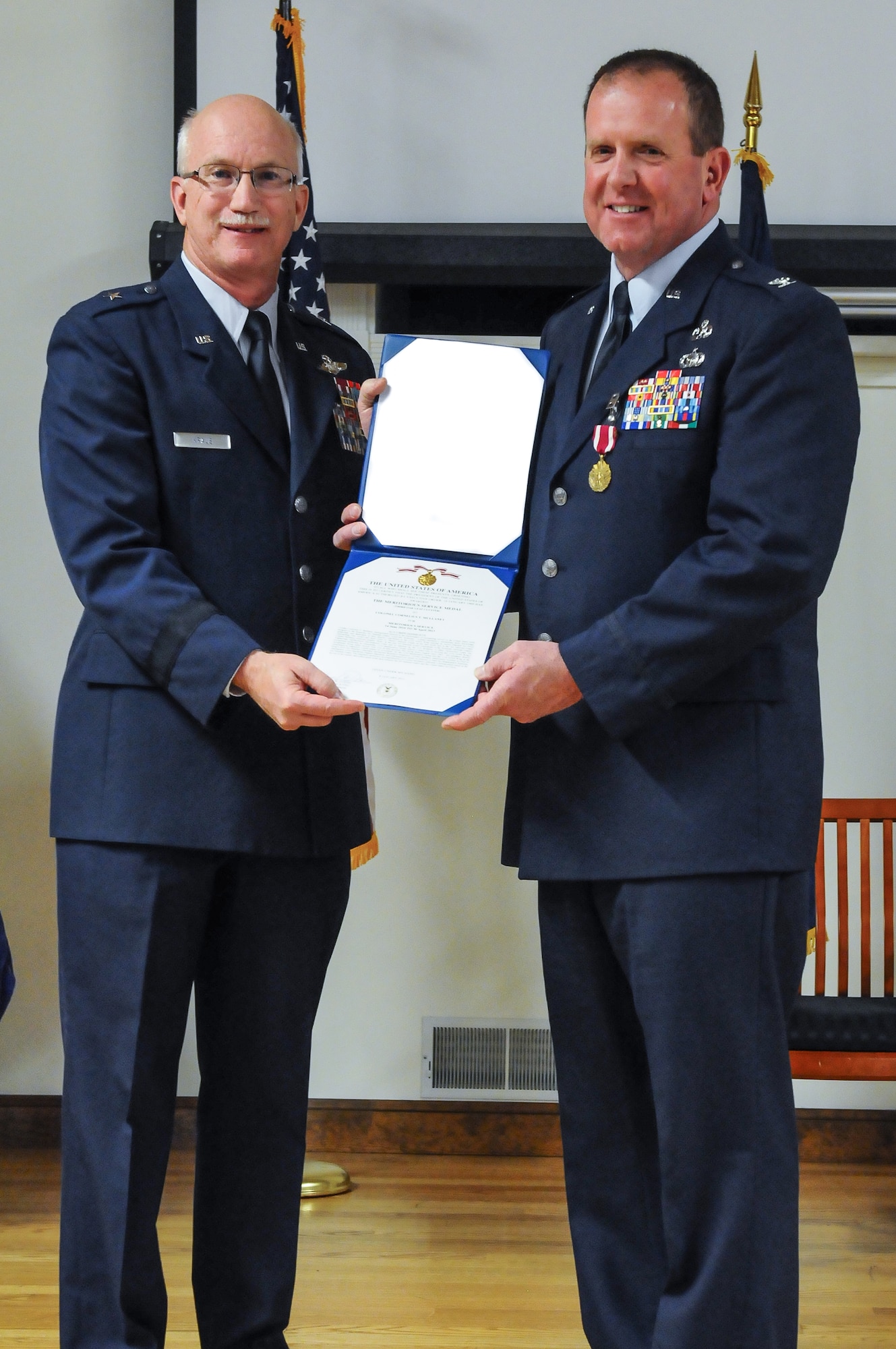 Col. Neil Mullaney (right), outgoing director of the Air Staff at Joint Forces Headquarters—Kentucky, receives a Meritorious Service Medal, third Oak Leaf Cluster, from Brig. Gen. Mark Kraus, Kentucky’s assistant adjutant general for Air, during a retirement ceremony Feb. 2, 2013, at the Kentucky Air National Guard Base in Louisville, Ky. Mullaney participated in four conflicts and commanded multiple units during his 24-year career. (U.S. Air Force photo illustration by Senior Airman Vicky Spesard, Kentucky Air National Guard)