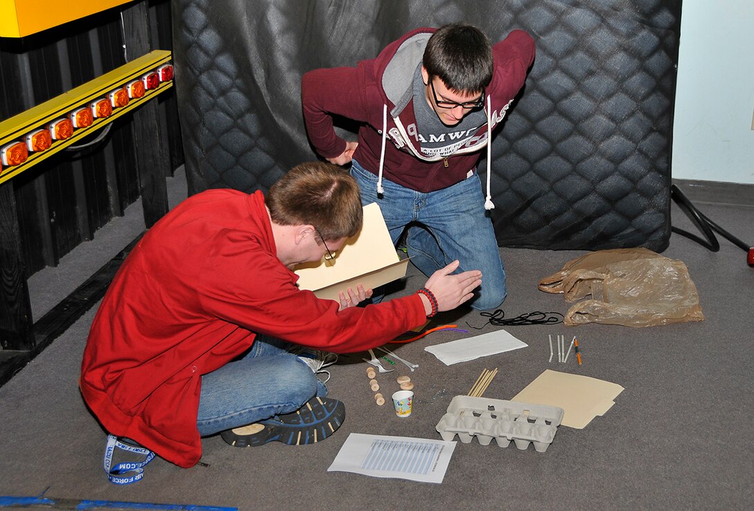 Jonathan Mares (left) and Andrew Eads, Tullahoma High School students, design their transport vehicle within the two hour time frame at the local National Engineers Week Design Competition. (Photo by Jacqueline Cowan)