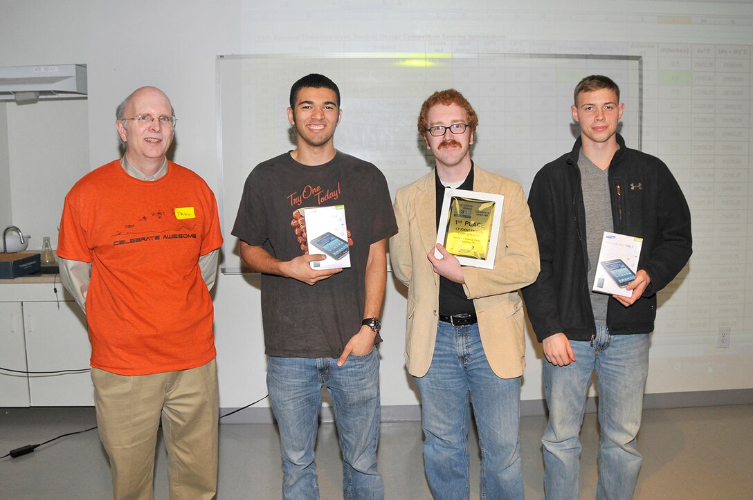 Paul Kelly (left), the National Engineers Week Design Competition coordinator, is shown with first place winners Trevor Arnold (second from left) and Steven McMillian (right) from Cascade High School, and Cascade High School Physics teacher Jon Higdon. (Photo by Jacqueline Cowan)