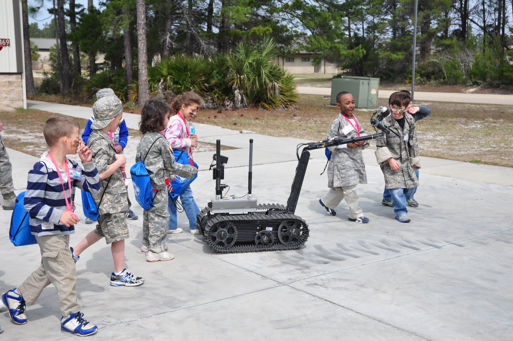 Team Tyndall dependents get a first hand look at an explosive ordnace disposal robot during Operation Jr. Raptor March 9. The event gives miltary children the chance to experience first hand what a deployment is like. (U.S. Air Force photo by 2nd Lt. Andrea Valencia)
