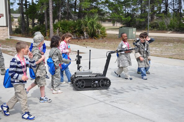 Team Tyndall dependents get a first hand look at an explosive ordnace disposal robot during Operation Jr. Raptor March 9. The event gives miltary children the chance to experience first hand what a deployment is like. (U.S. Air Force photo by 2nd Lt. Andrea Valencia)
