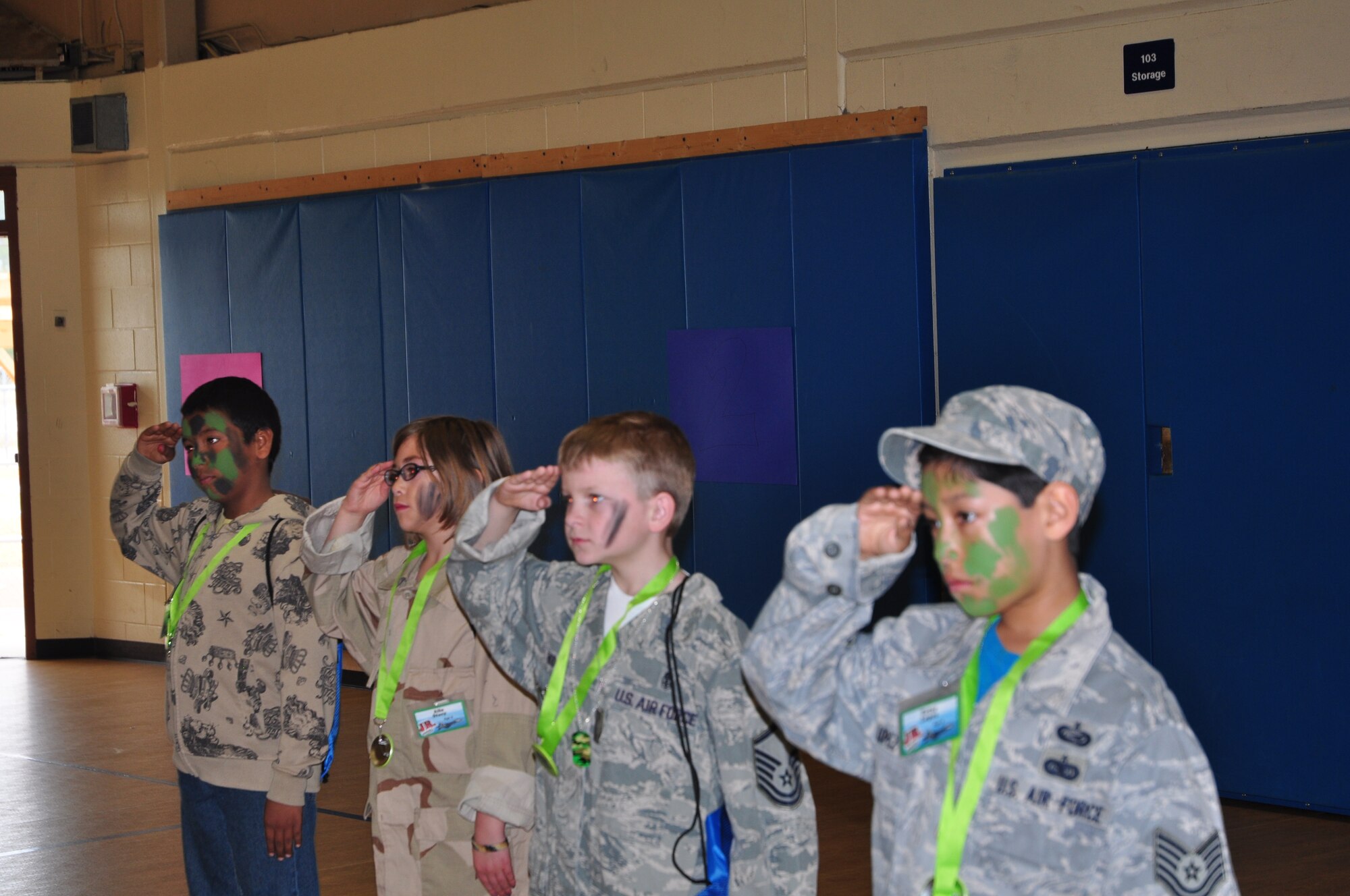 Team Tyndall dependents practice saluting during Operation Jr. Raptor March 9. The event gives miltary children the chance to experience first hand what a deployment is like. (U.S. Air Force photo by 2nd Lt. Andrea Valencia)
