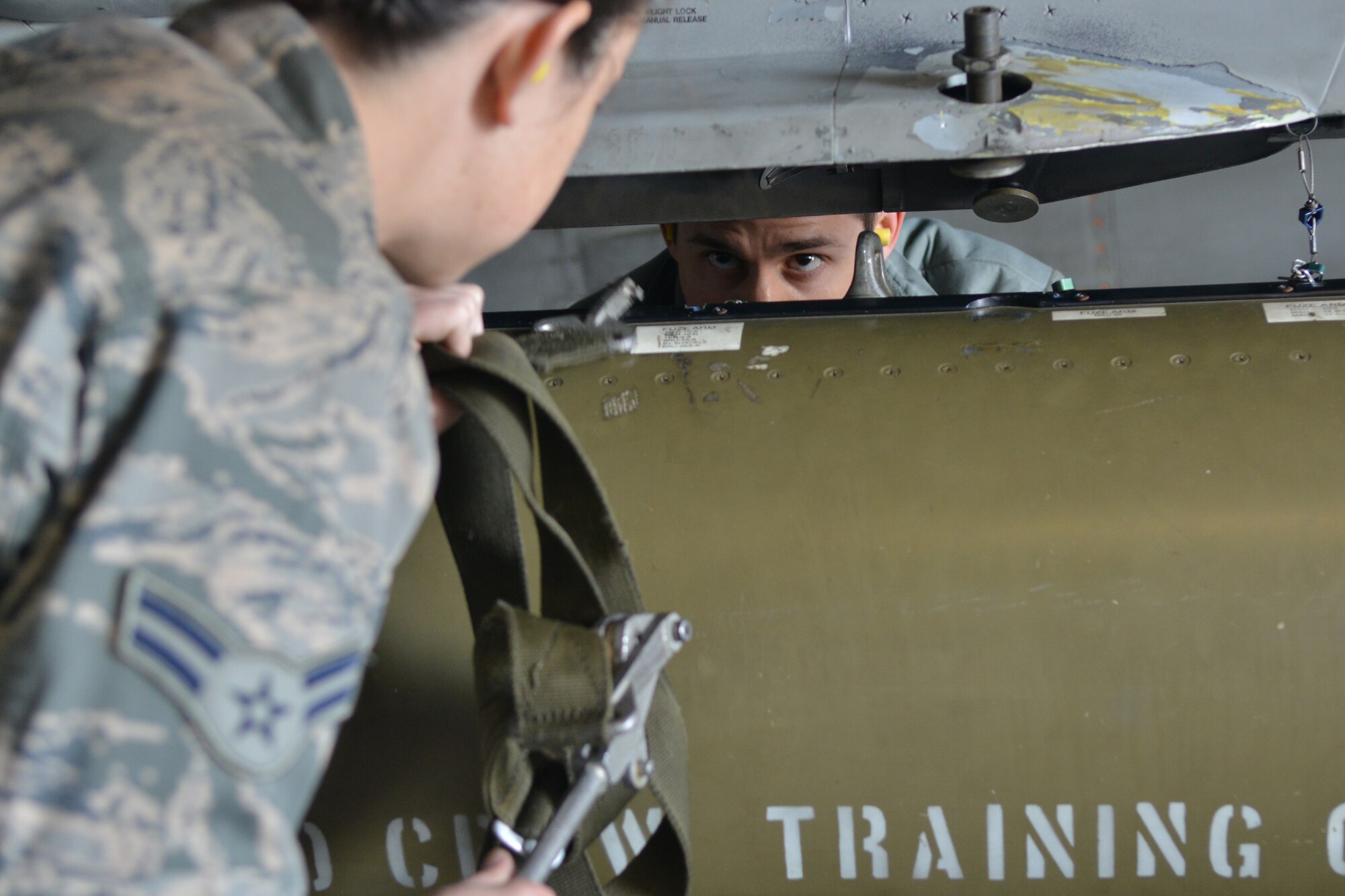 U.S. Air Force Staff Sgt. Matthew Quick and Airman 1st Class Victoria Baldwin-King, 20th Aircraft Maintenance Squadron load crew members, work together to complete the load test that they must pass to stay qualified to load and unload ammunitions, Shaw Air Force Base, S.C., March 7, 2013. The process for loading and unloading ammunitions ranges in between 60 and 150 steps. (U.S. Air Force photo by Airman 1st Class Ashley L. Gardner/Released)
