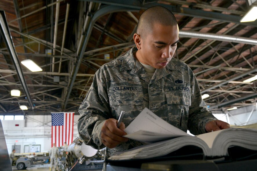 U.S. Air Force Tech. Sgt. Rolando Collantes, 20th Maintenance Operations Squadron standardization lead crew chief, goes through his tech data for the loading equipment, Shaw Air Force Base, S.C., March 7, 2013. The process for loading and unloading ammunitions ranges in between 60 and 150 steps. (U.S. Air Force photo by Airman 1st Class Ashley L. Gardner/Released)
