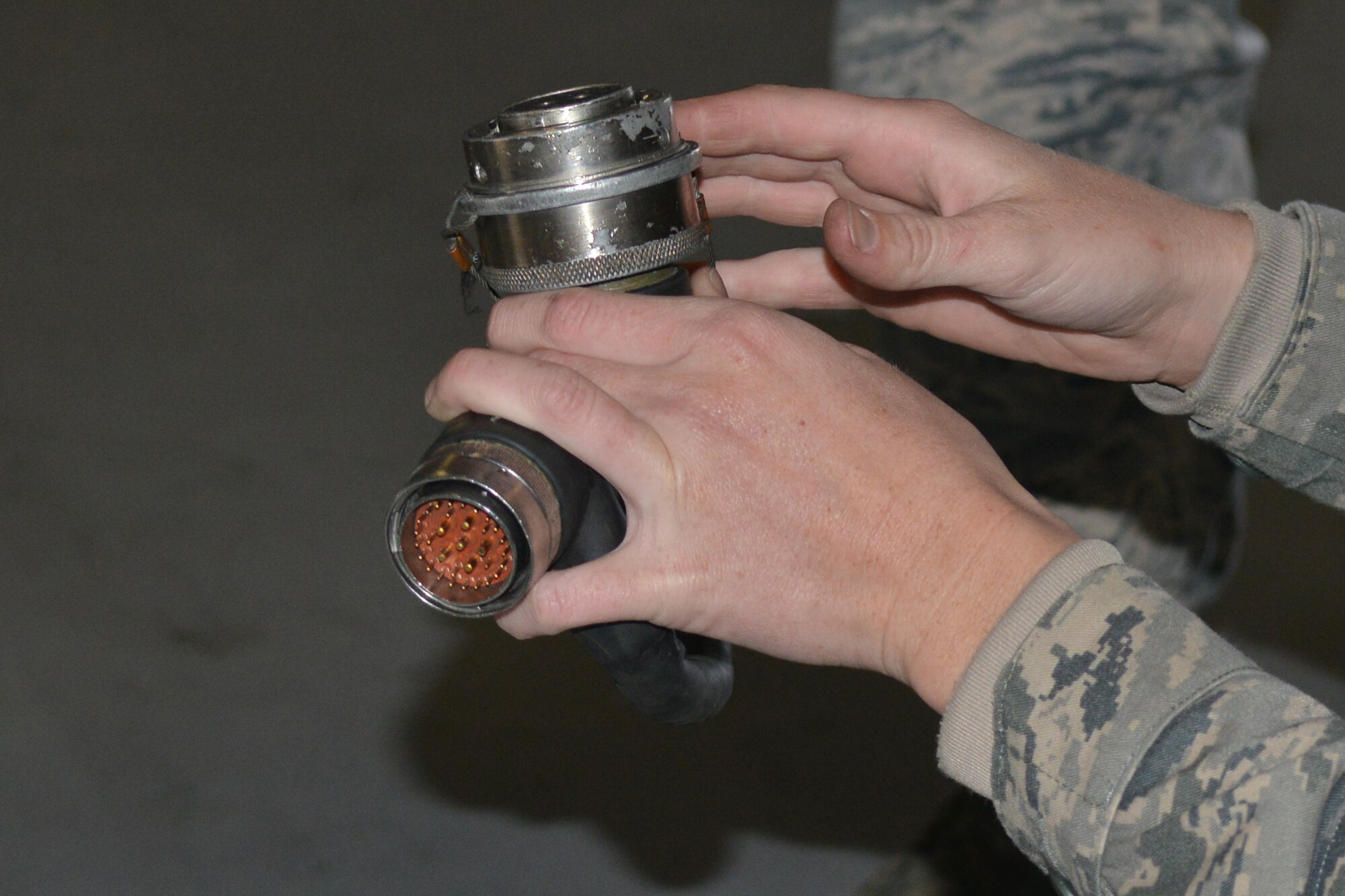 U.S. Air Force Airman 1st Class Victoria Baldwin-King, 20th Aircraft Maintenance Squadron load crew member, examines a metal piece of equipment to make sure it is in good condition, Shaw Air Force Base, S.C., March 7, 2013. The process for loading and unloading ammunitions ranges in between 60 and 150 steps. (U.S. Air Force photo by Airman 1st Class Ashley L. Gardner/Released)
