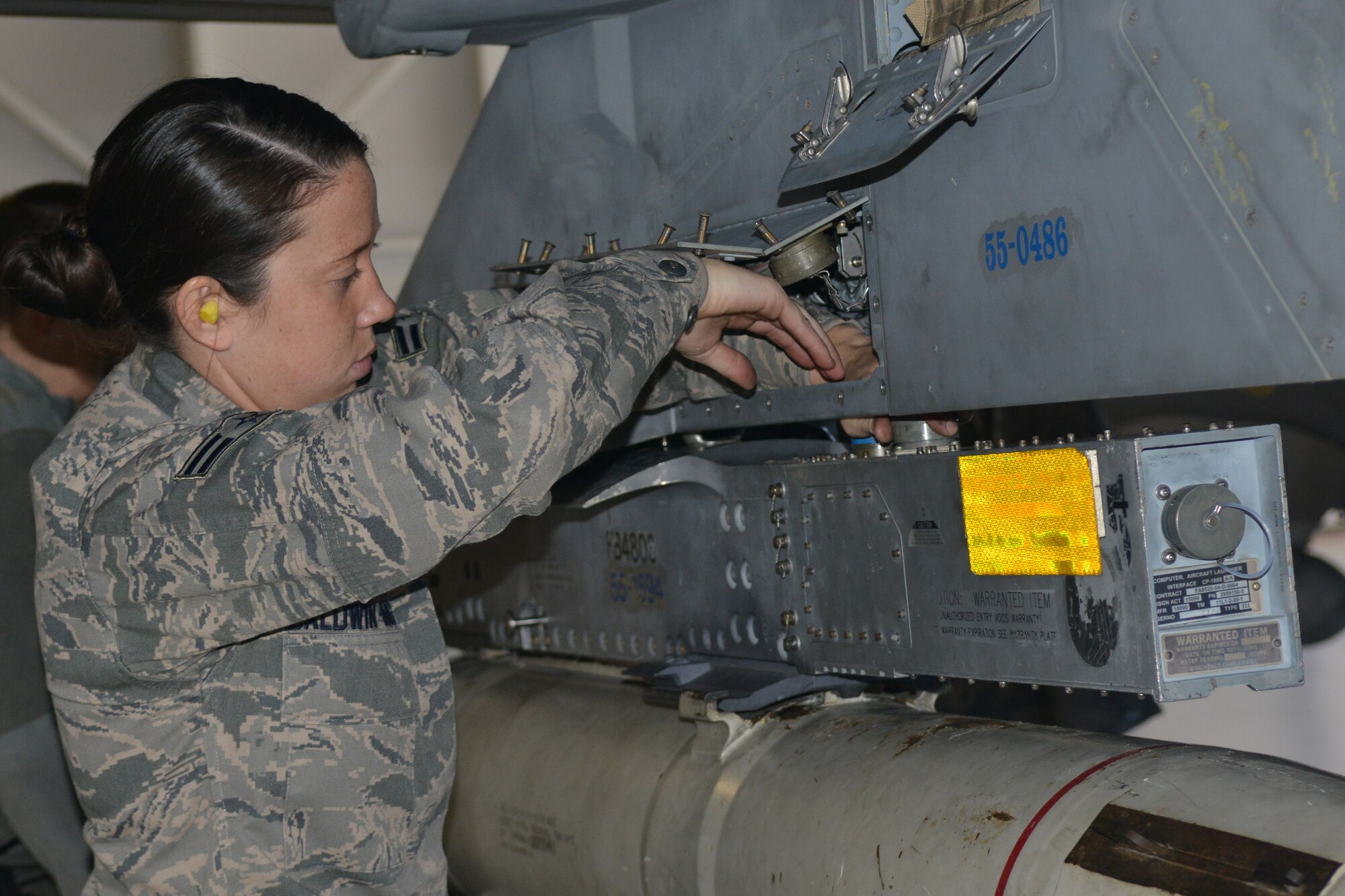 U.S. Air Force Airman 1st Class Victoria Baldwin-King, 20th Aircraft Maintenance Squadron load crew member, loads the F-16 Fighter Falcon, Shaw Air Force Base, S.C., March 7, 2013. The process for loading and unloading ammunitions ranges in between 60 and 150 steps. (U.S. Air Force photo by Airman 1st Class Ashley L. Gardner/Released)
