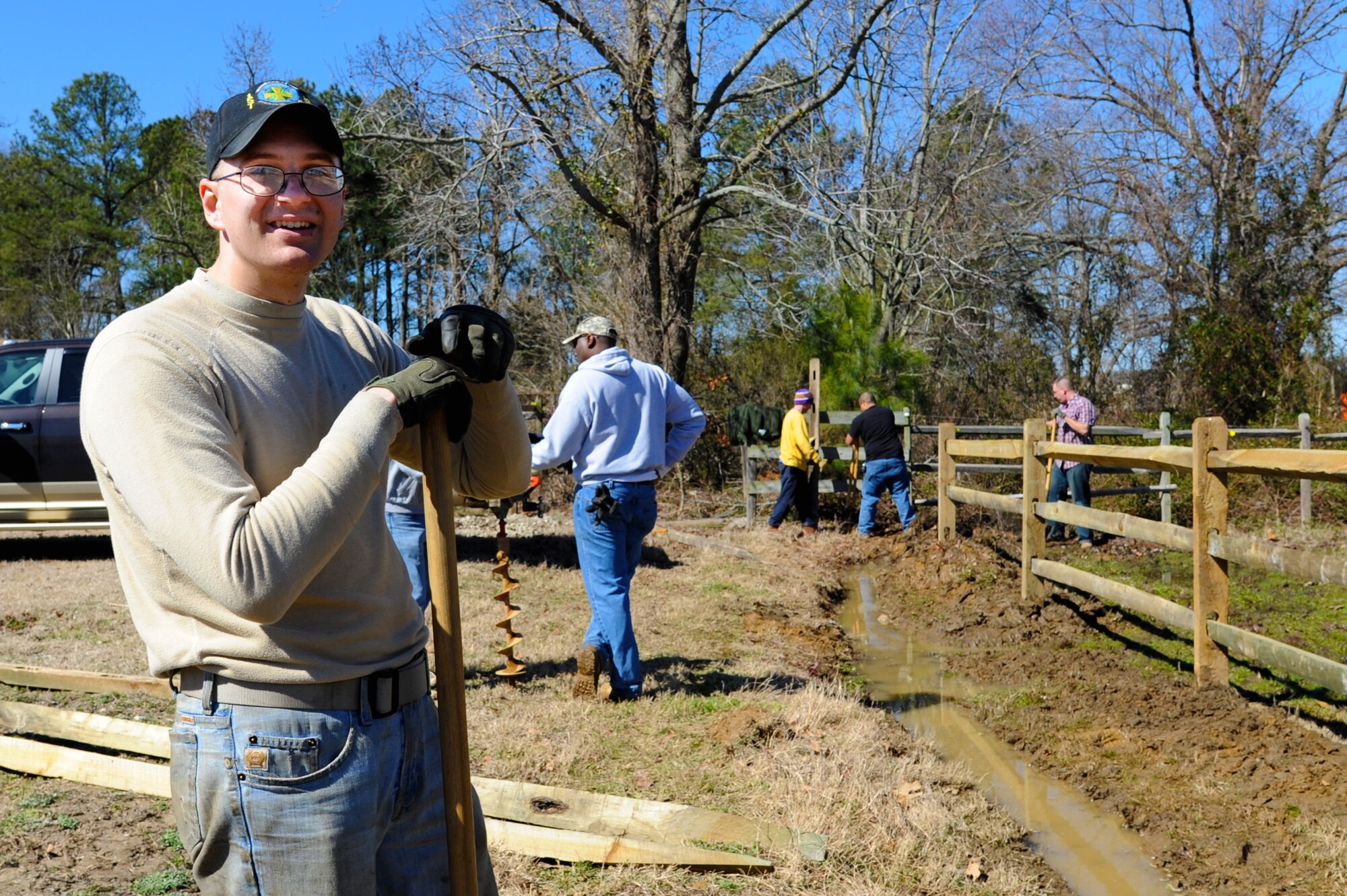 U.S. Air Force Staff Sgt. Douglas Teed, 633rd Communications squadron cable antenna system technician, helps build a fence with other volunteer Airmen at Langley Air Force Base, Va., March 9, 2013. Work parties at the Langley Stables are held the second Saturday of each month. (U.S. Air Force photo by Airman 1st Class Victoria Taylor/Released)