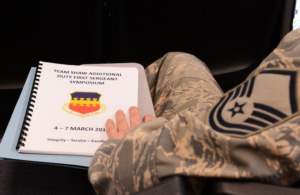 Team Shaw NCOs receive booklets for a first sergeants' symposium at Shaw Air Force Base, S.C., March 7, 2013. The symposium was for NCOs who are interested in becoming a first sergeant. They learned the duties that are associated with the job, received advice, as well as asked questions. (U.S. Air Force photo by Senior Airman Tabatha Zarrella/Released)
