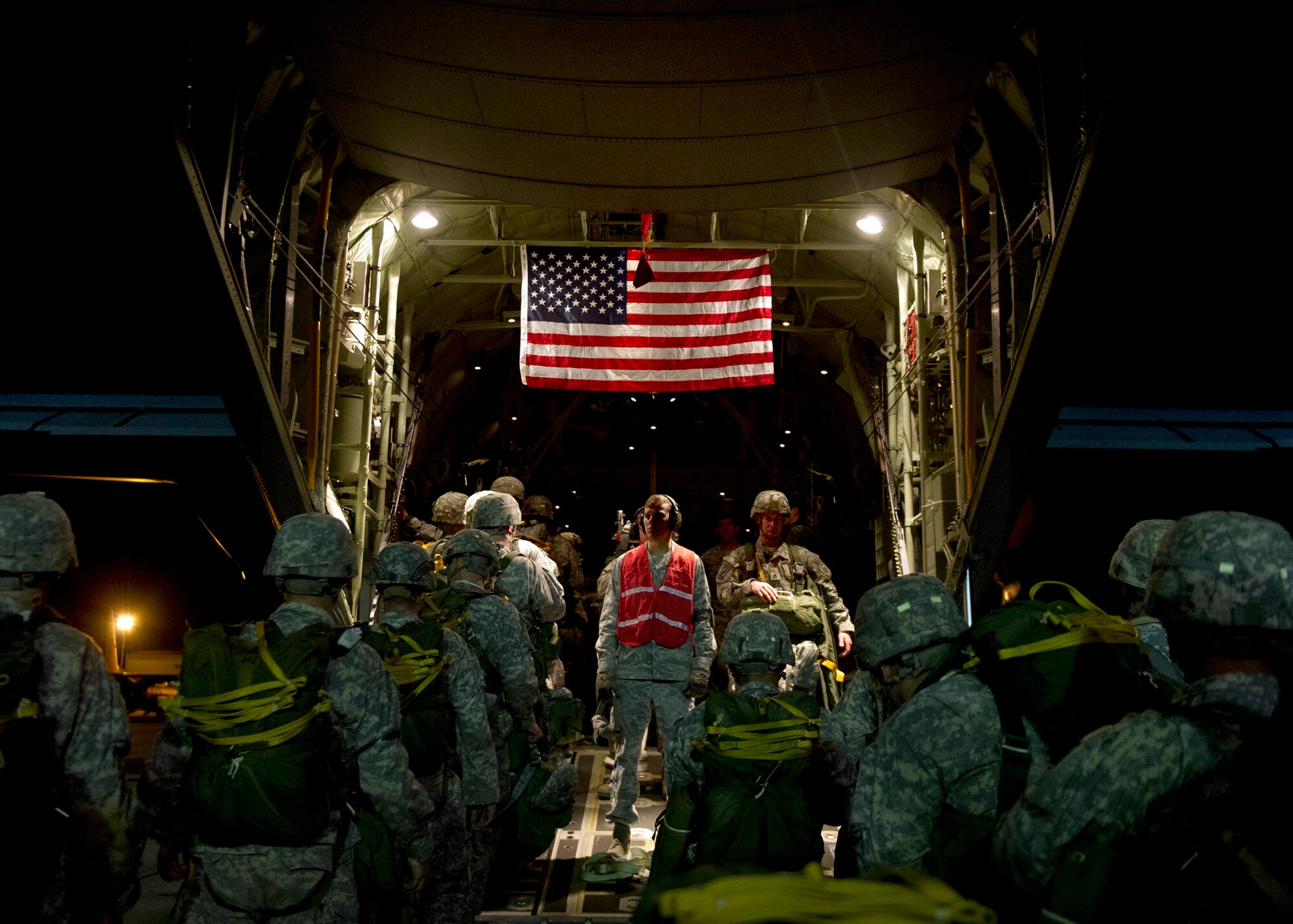 U.S. Air Force Airman 1st Class Douglas Moore, an air transportation technician with the 3rd Aerial Port Squadron, guides Soldiers onto an Air Force C-130J Hercules aircraft during Joint Operational Access Exercise 13-02 at Fort Bragg, N.C., Feb. 25, 2013. A JOAX is designed to enhance cohesiveness between U.S. Army, Air Force and allied personnel, allowing the services an opportunity to properly execute large-scale heavy equipment and troop movement.
