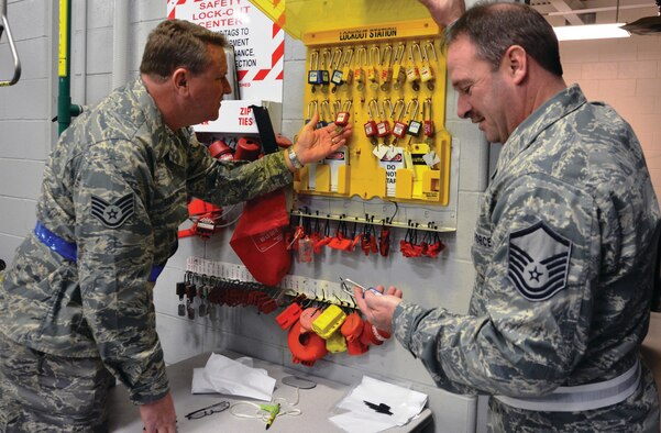 WRIGHT-PATTERSON AIR FORCE BASE, Ohio - Staff Sgt. Steven Sandman and Master Sgt. Richard Little, both ground safety specialists from the 445th Airlift Wing Safety office, perform a spot inspection of the control devices for the lockout/tagout program. (U.S. Air Force photo/Senior Airman Matthew Cook)