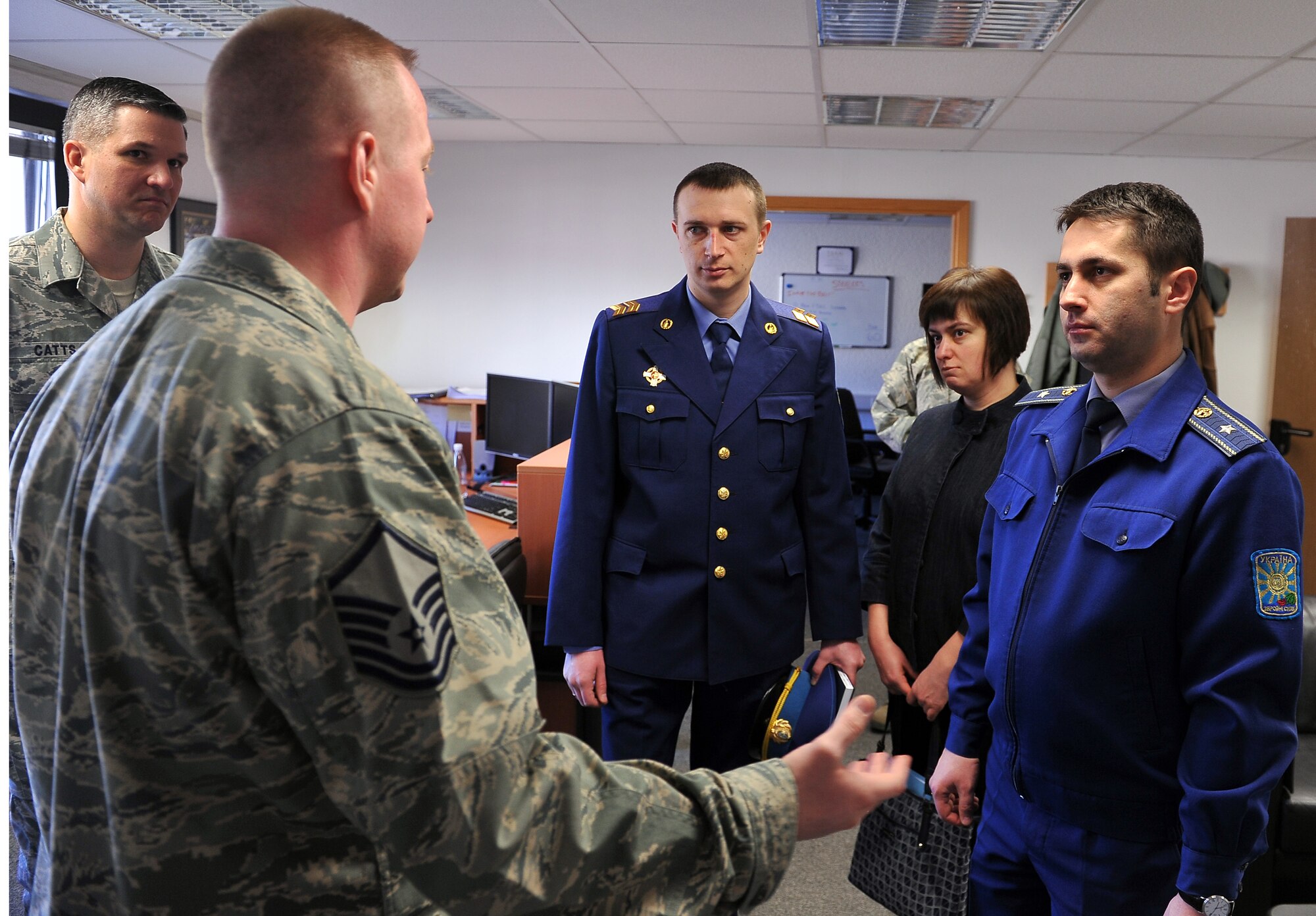 Master Sgt. Etienne P. Tousignant, 86th Force Support Squadron first term Airman course instructor, briefs visitors from the Ukrainian military on the importance of introducing new Airmen to the Air Force, as well as to the base, March 5, 2013, Ramstein Air Base, Germany. Members of the Ukrainian military visited the NCO academy to continue their professional military education operations and increase their knowledge in enlisted empowerment and leadership. (U.S. Air Force photo/Airman 1st Class Dymekre Allen)