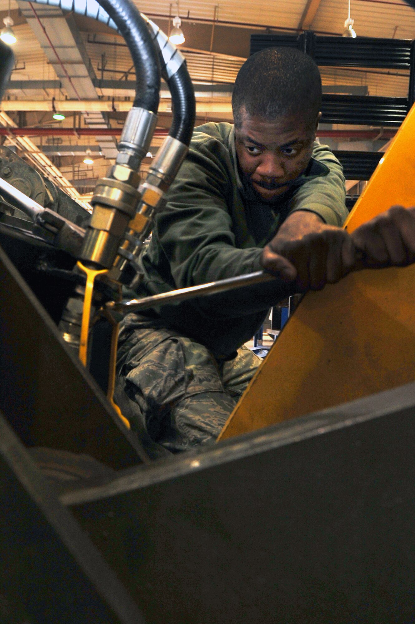 Airman 1st Class Benjamin George, 51st Logistics Readiness Squadron vehicle managment technician, tightens hydraulic fittings at the VM main shop at Osan Air Base, Republic of Korea, March 12, 2013. More than 80 mechanics work in the 84,000 square-foot facility. The main shop is uniquely consolidated in that it includes customer service, vehicle management and analysis, general purpose, special purpose and allied trades in the same building. (U.S. Air Force photo/Senior Airman Alexis Siekert)