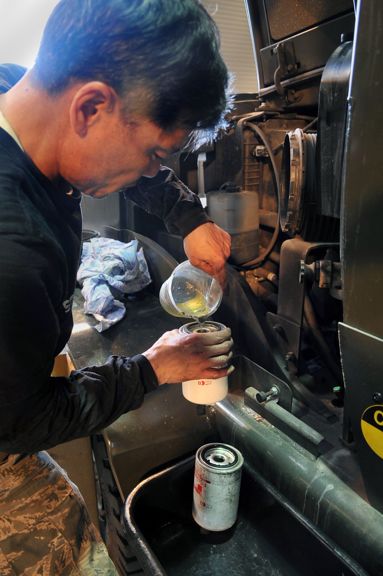 Wang, Yunha, 51st Logistics Readiness Squadron vehicle managment technician, changes a filter on a forklift at the VM main shop at Osan Air Base, Republic of Korea, March 12, 2013. VM mechanics perform all levels of maintenance from simple part changes to component rebuilds to full-service body repairs. (U.S. Air Force photo/Senior Airman Alexis Siekert)