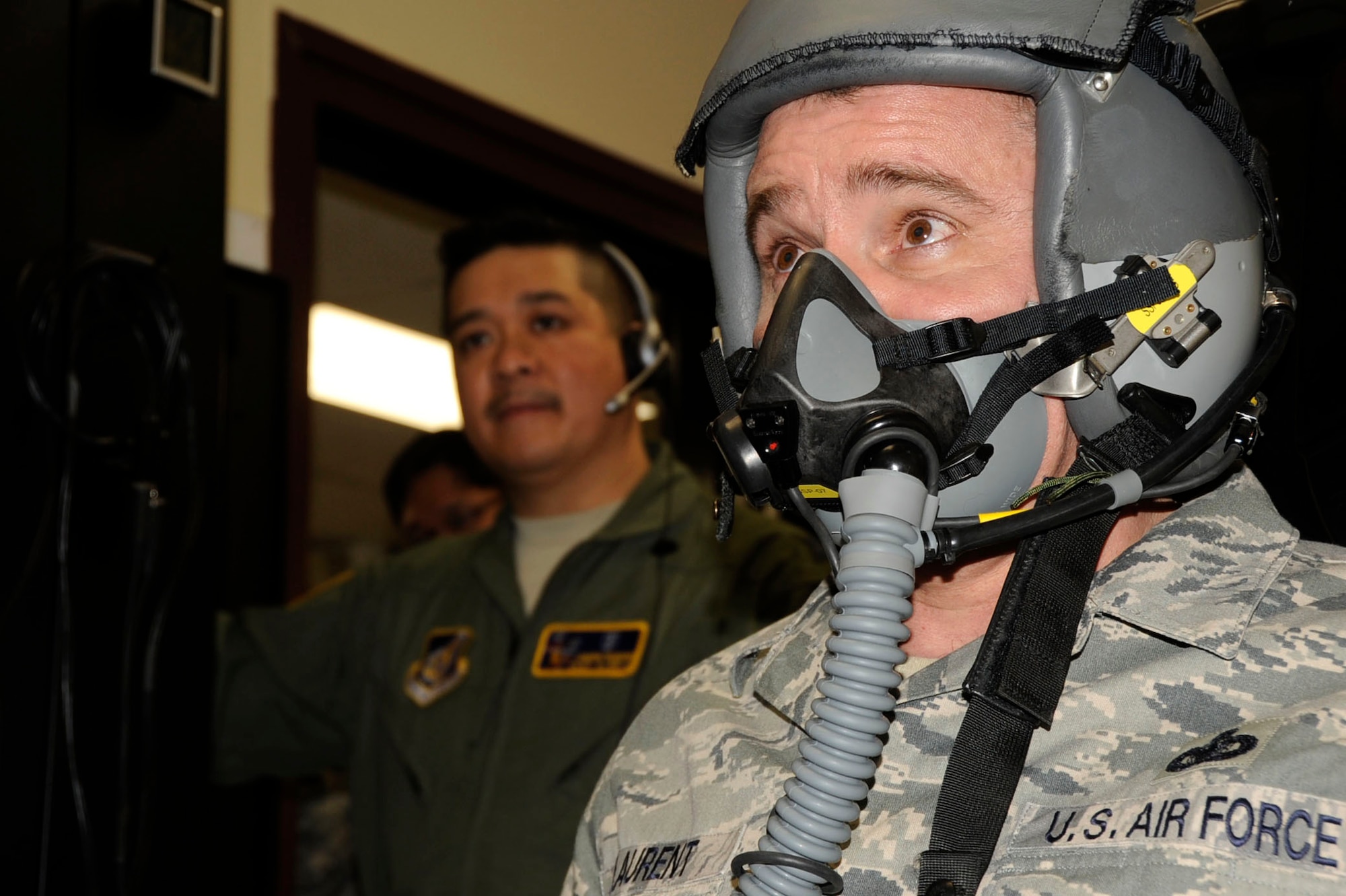 U.S. Air Force Chief Master Sgt. James Laurent, 35th Fighter Wing command chief, right, simulates flying the new hypoxia familiarization trainer while Capt. Joseph Teodoro, 35th Aerospace Medicine Squadron aerospace and operational physiologist, left, keeps watch over the chief’s oxygen levels in the 35th Operations Group building at Misawa Air Base, Japan, March 12, 2013. According to Teodoro, when a pilot is focused on flying, the signs of hypoxia can easily be overlooked. Recognizing the signs of hypoxia and knowing how to recover are a mandatory part of pilot training. (U.S. Air Force photo by Airman 1st Class Kenna Jackson)