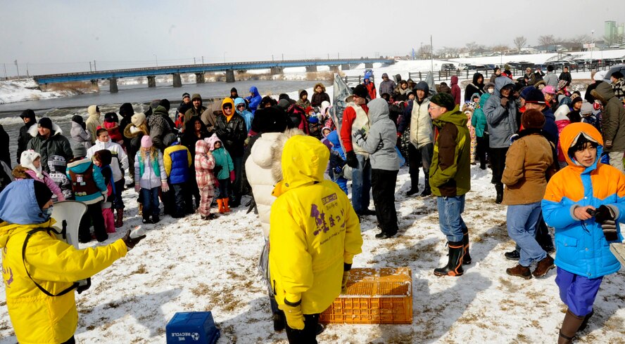 Hundreds of U.S. families gather at Oirase River for the 16th Annual Baby Salmon Release at Oirase Salmon Park in Oirase Town, Japan, March 9, 2013. The event allows families to release baby salmon into the river so they can breed and return as adults for the Oirase River Salmon Festival later in the year. (U.S. Air Force photo by Airman 1st Class Kenna Jackson)