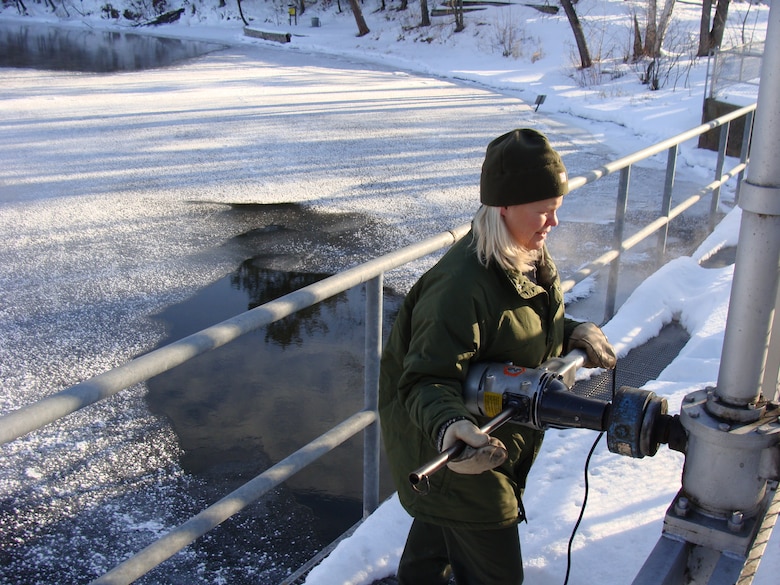 Mary Kay Larson, Gull Lake Recreation Area park manager, operates the dam during a gate change.