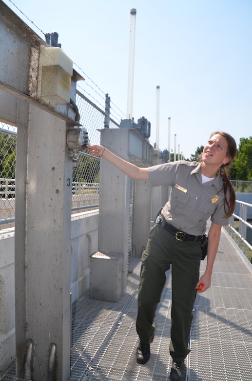 Renee Hanson, operations, adjusts the dam at the Crosslake Recreation Area Aug. 3, 2012.
