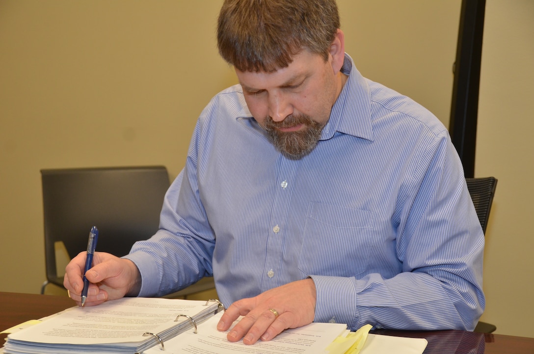 Brian Johnson, engineering and construction, reviews the Mississippi River Headwaters water
control manual at the district office in St. Paul, Minn., Feb. 22.