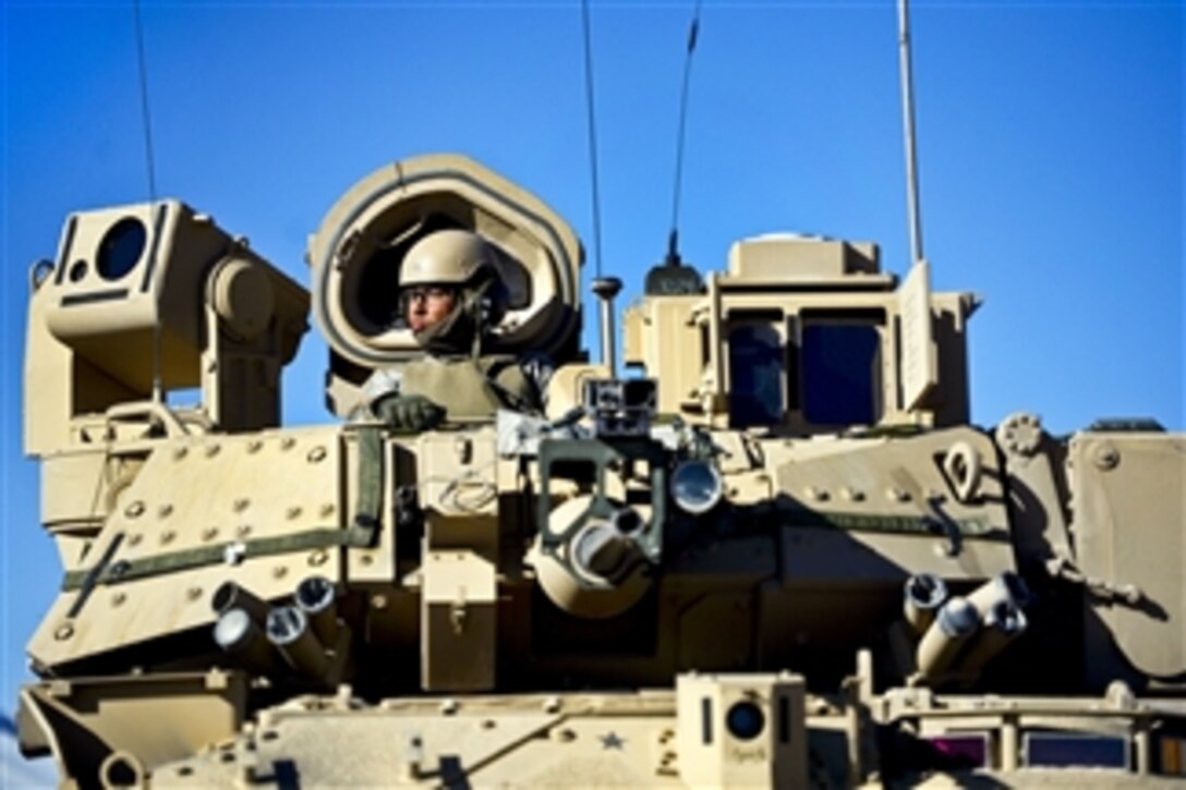 A U.S. Army soldier keeps watch from the hatch of his Bradley Fighting Vehicle at the National Training Center in Fort Irwin, Calif., on Feb. 24, 2013.  The soldier and his vehicle are attached to the 2nd Armored Brigade Combat Team, 1st Infantry Division of Fort Riley, Kan.   