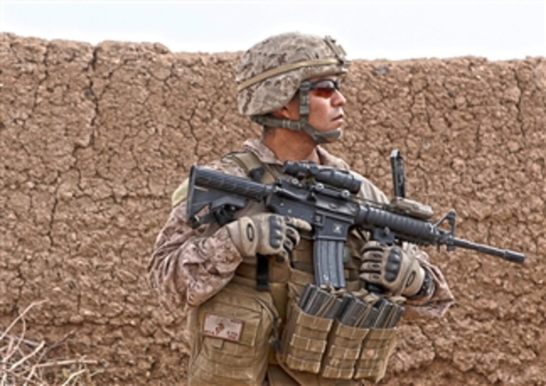 U.S. Marine Corps Staff Sgt. Pablo Nieto sweeps a compound during a patrol near Patrol Base Boldak in Afghanistan on March 7, 2013.  Nieto is a member of Weapons Company, 2nd Battalion, 7th Marine Regiment.  