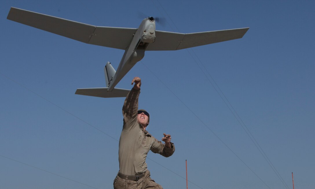 Lance Cpl. Nathan Bush launches the Puma during an operation at Patrol Base Boldak March 4. To operate, the Puma must be launched by hand. Bush s a member of Weapons Company with 2nd Battalion, 7th Marine Regiment. (Photo by Sgt. Bobby J. Yarbrough)