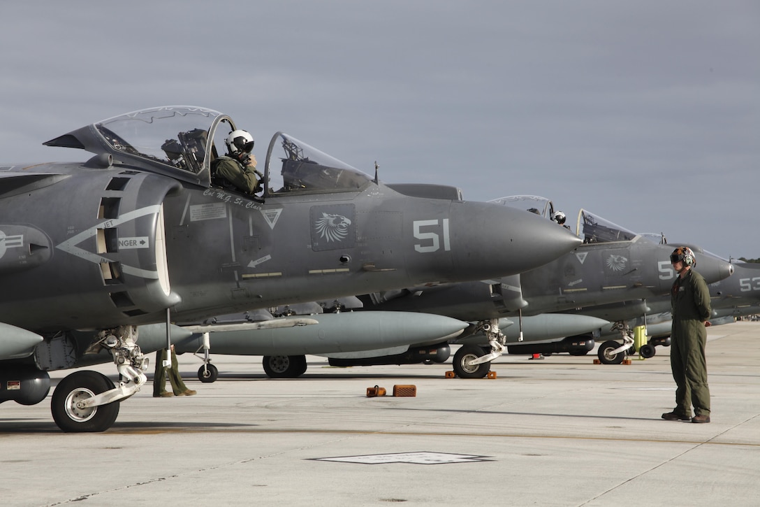 An AV-8B Harrier pilot with Marine Attack Squadron 231 sits in his aircraft and checks his equipment before departing Cherry Point March 11. Approximately 80 Marines and Sailors with VMA-231 departed Cherry Point to support operations with the 26th Marine Expeditionary Unit.
