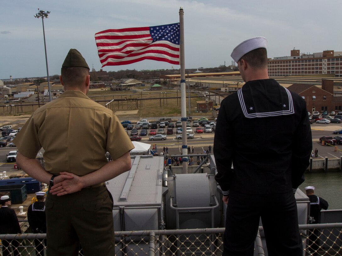 Marines and Sailors assigned to the 26th Marine Expeditionary Unit, and Sailors assigned to the USS Kearsarge (LHD 3), man the rails while departing Naval Station Norfolk, Va., to embark on their deployment March 11, 2013. The 26th MEU is deploying to the 5th Fleet and 6th Fleet areas of operation. The MEU operates continuously across the globe, providing the president and unified combatant commanders witha  a forward-deployed, sea-based, quick-reaction force. The MEU is a Marine Air-Ground Task Force capable of conducting amphibious operations, crisis-response and limited contigency operations. (U.S. Marine Corps photo by Cpl. Kyle N. Runnels/Released)