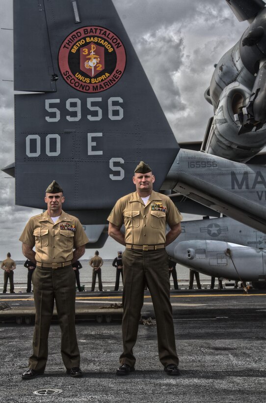 Lt. Col. Charles R. Cassidy, commanding officer of Battalion Landing Team 3/2, 26th Marine Expeditionary Unit, and Sgt. Maj. James S. Moran, BLT 3/2 sergeant major, man the rails while departing Naval Station Norfolk, Va., to embark on their deployment March 11, 2013. The 26th MEU is deploying to the 5th Fleet and 6th Fleet areas of operation. The MEU operates continuously across the globe, providing the president and unified combatant commanders witha  a forward-deployed, sea-based, quick-reaction force. The MEU is a Marine Air-Ground Task Force capable of conducting amphibious operations, crisis-response and limited contigency operations. (U.S. Marine Corps photo by Cpl. Kyle N. Runnels/Released)